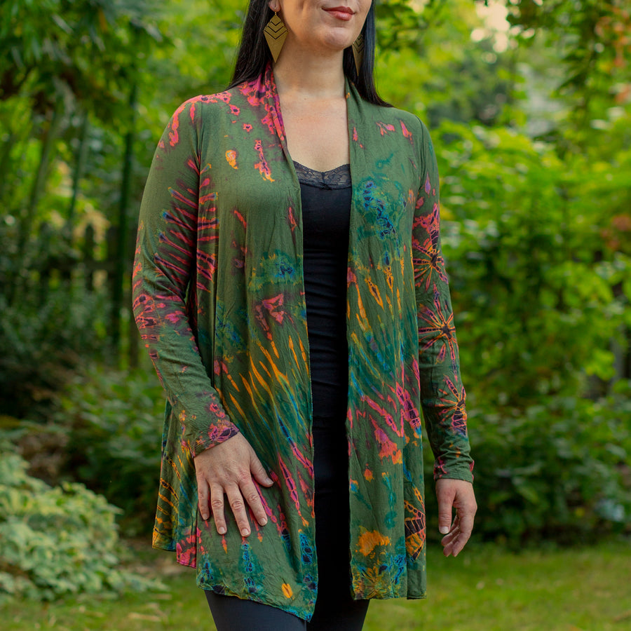 Model wearing Autumn Green Tie Dye Long Cardigan with stripes and starburst patterns in gold, red and blue