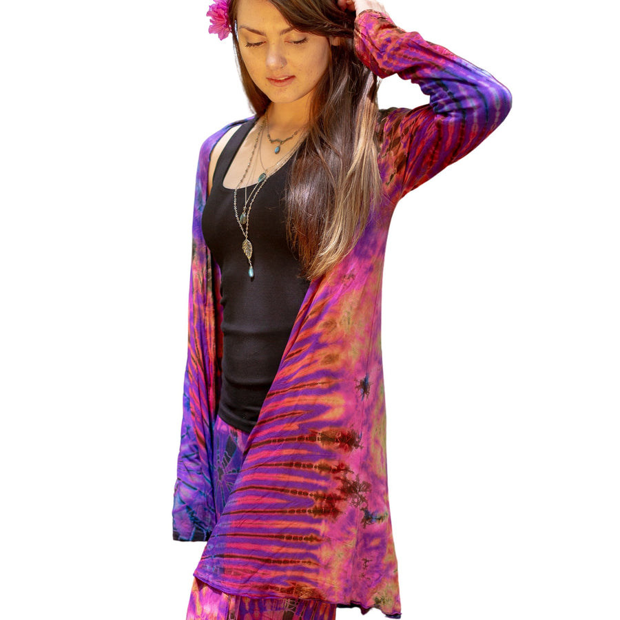 Model wearing Purple Tie Dye Long Cardigan with stripes and starburst patterns in yellow, gold, orange, pink and fuchsia