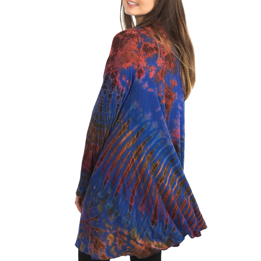 Model wearing Royal Blue Tie Dye Long Cardigan with stripes and starburst patterns in gold, dark red and burnt 